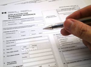 Toronto, Canada - April 23 2017: Somebody filling an application for permanent residence in Canada.