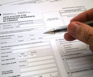 Toronto, Canada - April 23 2017: Somebody filling an application for permanent residence in Canada.