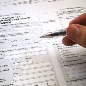 Toronto, Canada - April 23 2017: Somebody filling an application for permanent residence in Canada.