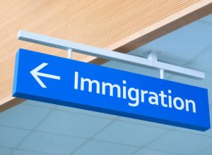 Immigration sign in airport. Airport inscription pointer. Immigration concept photo. Passport control sign with arrow pointer. Official service signpost. Immigration issue banner template