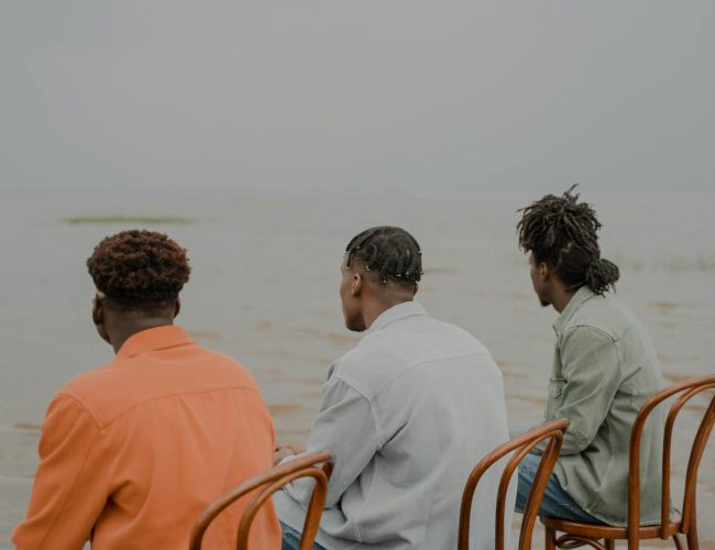 men of different hairstyles looking at sea