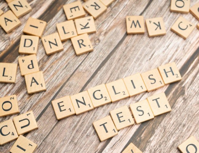 the word english test is spelled out in scrabble tiles