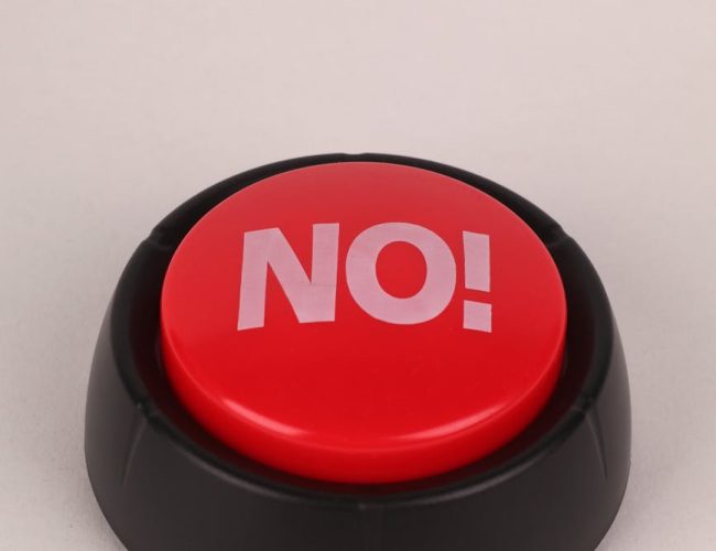 red no button on white surface
