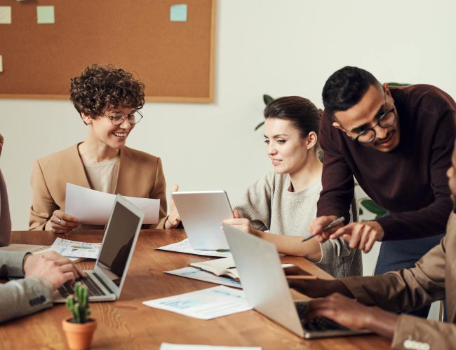 group of people gathered around wooden table