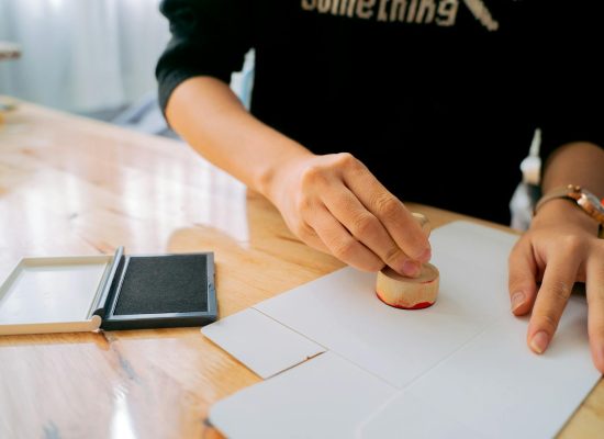 Photo by Anna Tarazevich on <a href="https://www.pexels.com/photo/a-person-s-hand-using-a-stamp-6358840/" rel="nofollow">Pexels.com</a>