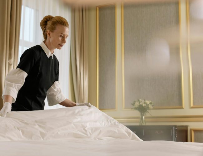 woman fixing the bed
