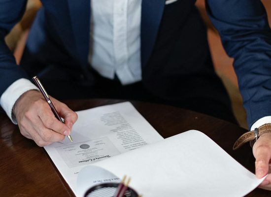 Photo by Mikhail Nilov on <a href="https://www.pexels.com/photo/elegant-man-signing-documents-8730998/" rel="nofollow">Pexels.com</a>