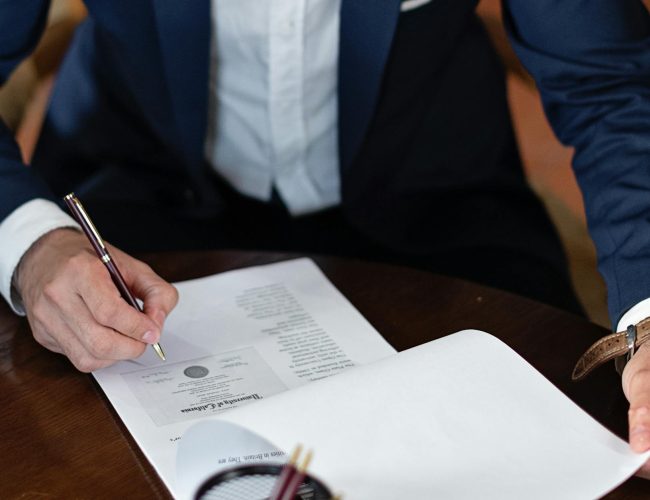 elegant man signing documents